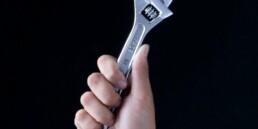 person holding gray and black metal tool